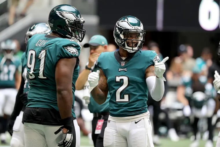 Eagles defensive tackle Fletcher Cox (left) and cornerback Darius Slay (right) laughing during Sunday's victory over the Atlanta Falcons.