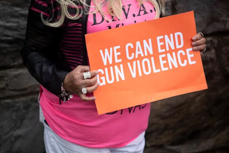Reverend Jeanette Davis, from D.I.V.A. ministry group, holds a poster reading "We Can End Gun Violence," outside of the Cobbs Creek Recreation Center in Philadelphia, Pa. on Sunday, April 11, 2021.