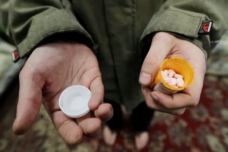 In this Nov. 14, 2019 photo, Jon Combes holds his bottle of buprenorphine, a medicine that prevents withdrawal sickness in people trying to stop using opiates, as he prepares to take a dose in a clinic in Olympia, Wash. Pandemic waivers on telehealth have enabled clinicians to prescribe buprenorphine without an in-person evaluation. Now, as waivers are set to expire, that program is at risk.