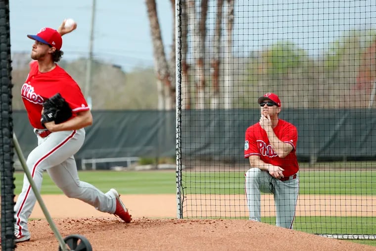 Phillies' guest instructor Brad Lidge, right, watches Aaron Nola pitch at Phillies Spring Training in Clearwater, Fl on February 18, 2017.