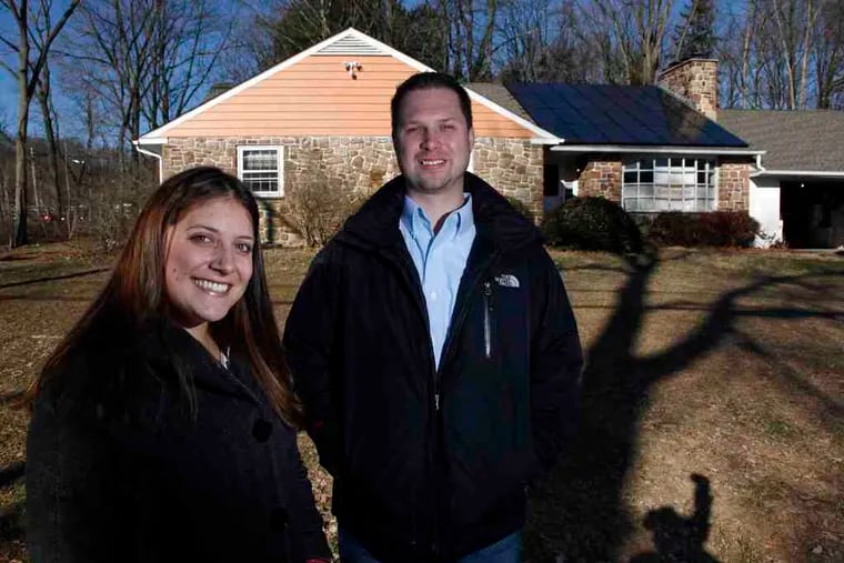 Above, Kira Costanza, director of marketing for Solardelphia, with Jude Webster, president, at their office in Doylestown, which sports a new solar array on the roof. Below, Kira with her father, Jon, president of Sunpower Builders in Collegeville, last year, when they were still working together.