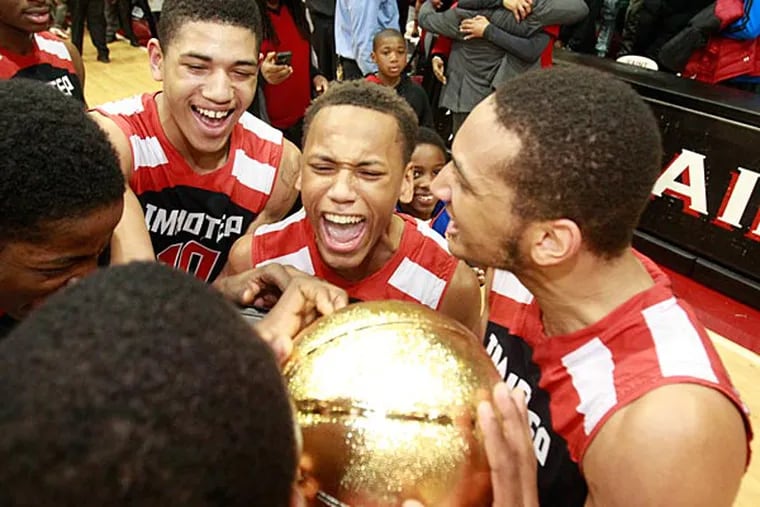 Imhotep's Nysir Marshburn, Daron Russell, and Devin Liggeons and others swarm around the Public League trophy. (Charles Fox/Staff Photographer)