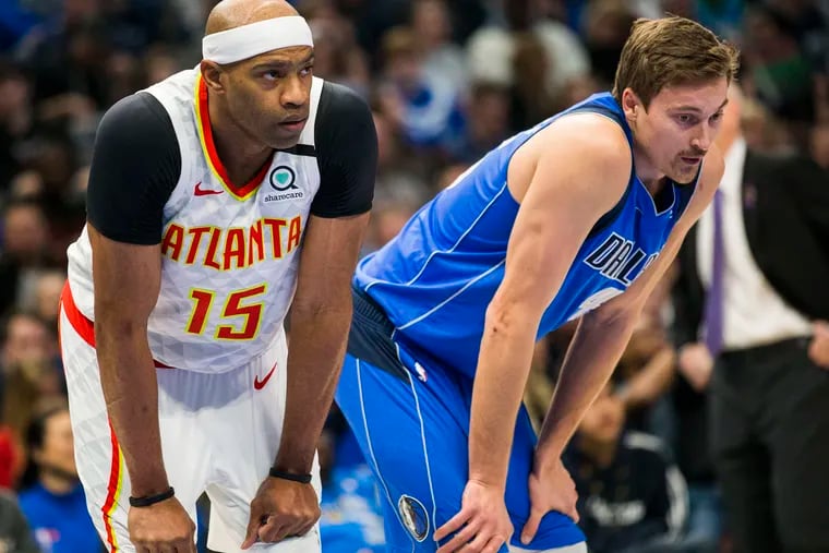 Ryan Broekhoff (right) stands with Atlanta's Vince Carter in February.