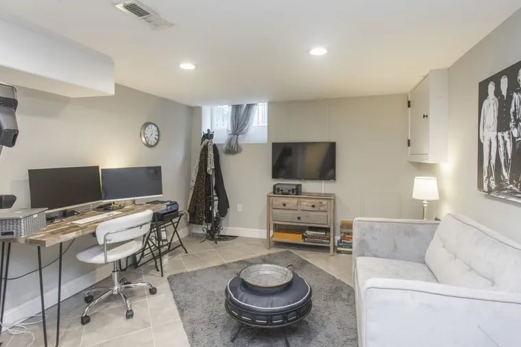 The fully finished basement has high ceilings, a half bath and a laundry room. It's currently used as an office/workout space.
