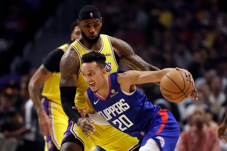 The Clippers' Landry Shamet (20) trying to drive against the Lakers' LeBron James during an October game.