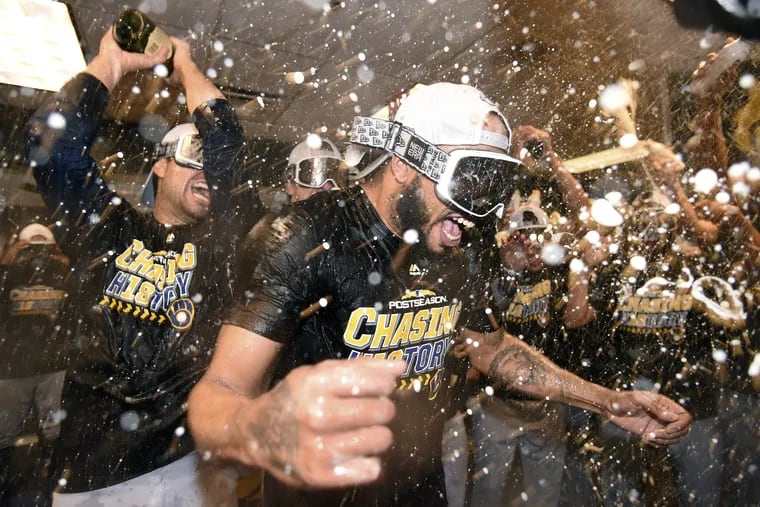 Brewers reliever Jeremy Jeffress is doused by teammates as they celebrate after sweeping the Rockies in three games to win the NLDS.