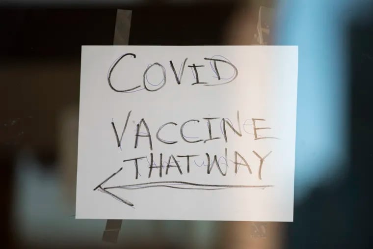 Signage directs people waiting for a coronavirus vaccine distribution by the Black Doctors COVID-19 Consortium at Deliverance Evangelistic Church in Philadelphia, Pa. on Thursday, January 28, 2021.
