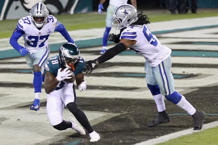 Jalen Reagor caught this two-point conversion pass, and a touchdown pass against Dallas. But he accounted for just 16 yards on three catches in his first game back from a broken thumb.