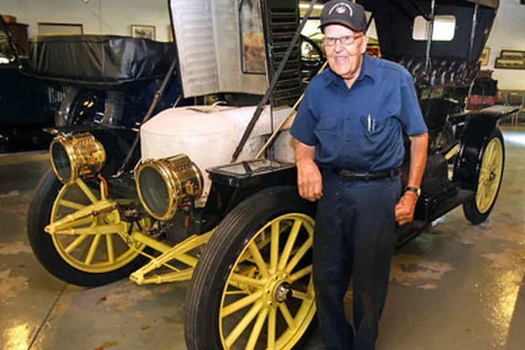 Tom Marshall stands next to a 1910 Stanley Steamer, one of 15 in his collection. RON CORTES / Staff Photographer