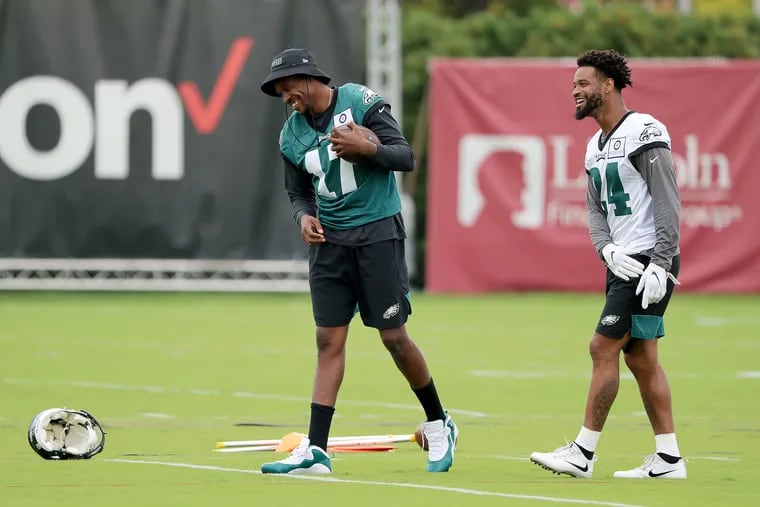 Wide receiver Alshon Jeffery (left) and Eagles cornerback Darius Slay share a laugh at practice last week.