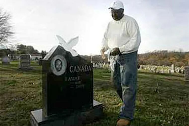 Ted Canada cleans the headstone of his son Lamar's grave at Merion Memorial Park in Bala Cynwyd. Lamar Canada was shot to death in July 2005. The next year, a witness to the slaying was himself killed, 10 days after testifying at a preliminary hearing. (David Swanson / Staff Photographer)