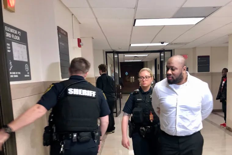 Blair Watts is escorted out of a courtroom in the Montgomery County Courthouse on Wednesday. Watts is charged with first- and third-degree murder in the death of Jennifer Brown, his business partner.