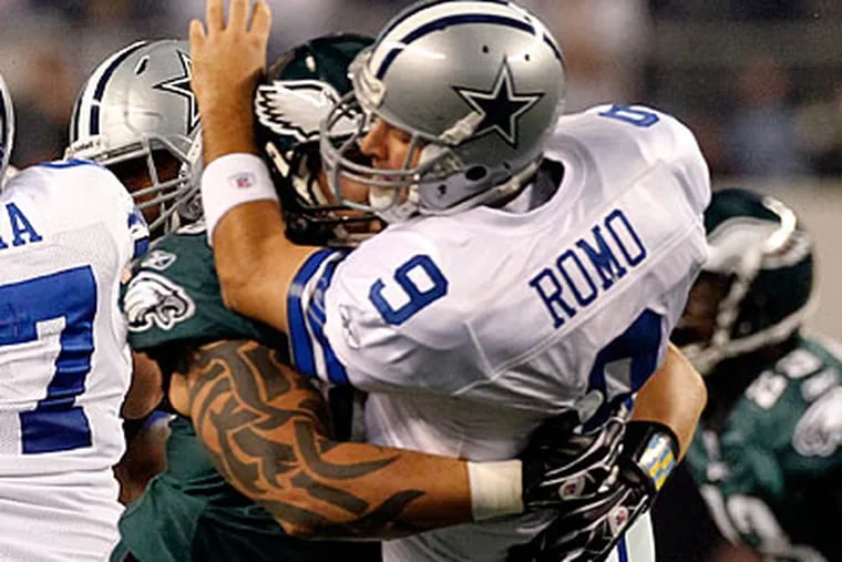 Jason Babin slams into Cowboys quarterback Tony Romo, forcing him out of the game. (Ron Cortes/Staff Photographer)