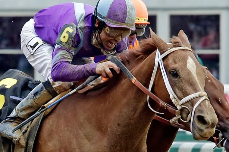 Mike Smith rides Princess of Sylmar to a win over Beholder ridden by Garrett Gomez in the 139th Kentucky Oaks at Churchill Downs in May 2013, in Louisville, Ky. (J. David Ake/AP)