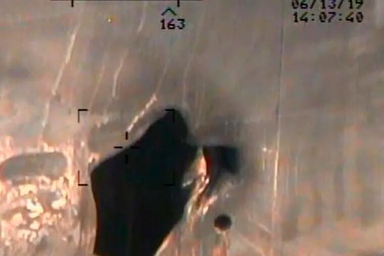 This image released by the U.S. Department of Defense on Monday, June 17, 2019, and taken from a U.S. Navy helicopter, shows what the Navy says is blast damage to the motor vessel M/T Kokuka Courageous, consistent with a limpet mine attack.  (U.S. Department of Defense via AP)