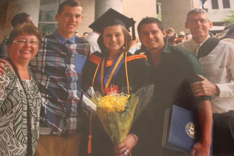 Emily Fredricks, shown with her family after graduating from college, was struck and killed by a garbage truck while riding her bicycle in 2017.