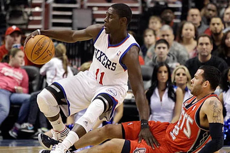 Jrue Holiday and the Sixers are 8-9 in their last 17 games. (Matt Slocum/AP)