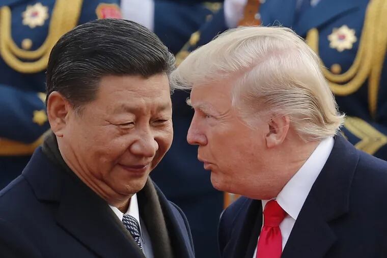 President Trump chats with Chinese President Xi Jinping during a welcome ceremony at the Great Hall of the People in Beijing on  Nov. 9.