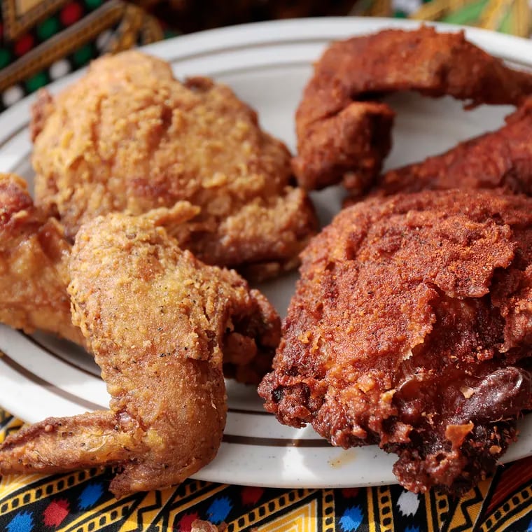 The gluten-free fried chicken, a milder “Alicha” (left) and the spicy red “Awaze” at Doro Bet, 4533 Baltimore Ave. in Philadelphia.