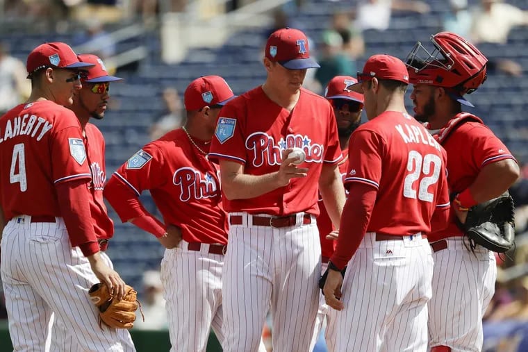 Phillies pitcher Nick Pivetta hands the baseball to manager Gabe Kapler after getting pulled during the second inning.