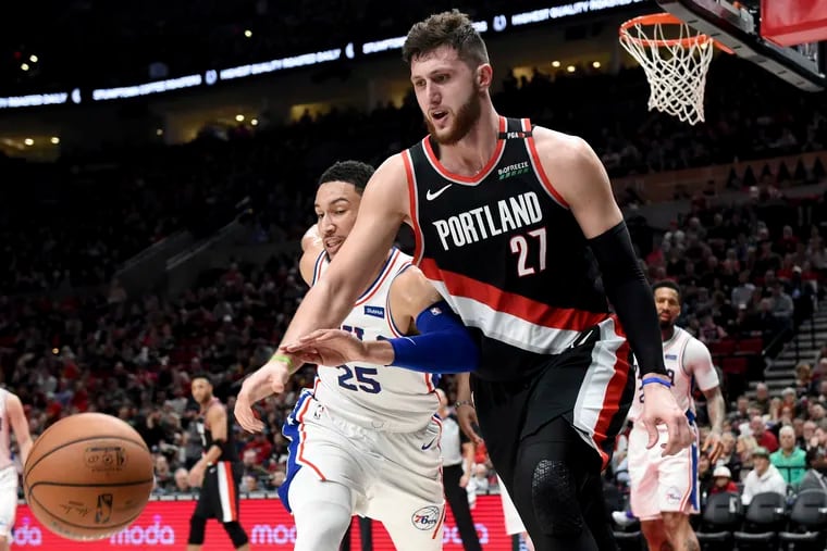 Ben Simmons, chasing after the ball against Portland's Jusuf Nurkic, scored 19 points Sunday. The Sixers struggled as a whole, however, in a 129-95 loss to the Blazers. (Steve Dykes / AP Photo)