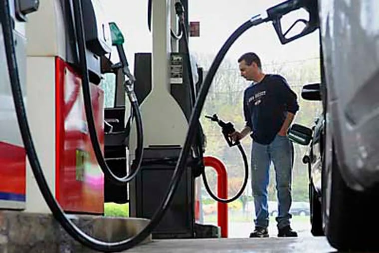 FILE- In this April 28, 2011 file photo, John Magel, of Wetherfield, pumps gas at a station in Wethersfield, Conn. U.S. consumers paid more for gas and food in April, pushing inflation to its highest level in two and a half years. But so far in May 2011, inflationary pressures have begun to ease. (AP Photo/Jessica Hill)
