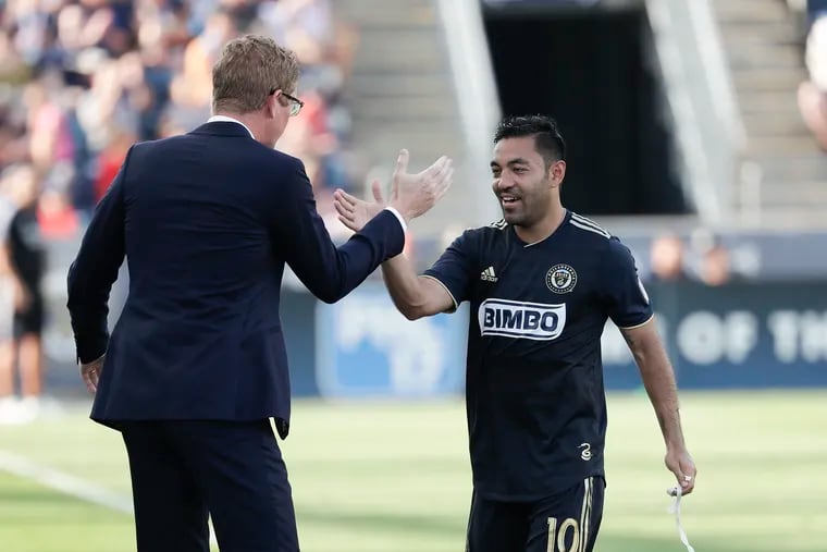 Union midfielder Marco Fabián (right) with manager Jim Curtin.