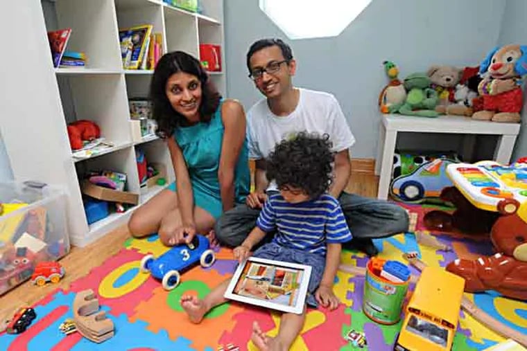 Wharton professor Kartik Hosanagar and his wife, Prasanna Krishnan, both technologists and entrepreneurs, watch their 2 1/2-year-old son, and primary beta-tester, Aarav Hosanagar play their new app titled Zoo Pal - A Gift on an iPad in his room.  The couple was frustrated by the static experiences their toddler son was getting whenever they let him play with an iPad. That frustration led to a new venture, SmartyPAL, which will soon launch what the couple hope will be a series of apps that mix storytelling with interactive challenges.  ( CLEM MURRAY / Staff Photographer )