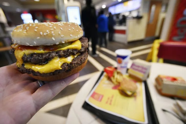 A McDonald's Double Quarter Pounder is shown with the new fresh beef Tuesday, March 6, 2018, in Atlanta. McDonald's is offering fresh beef rather than frozen patties in some burgers at thousands of restaurants, a switch it first announced about a year ago as it works to appeal to customers who want fresher foods.