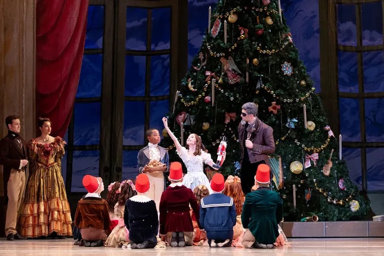 Isabella DeBiasio as Marie tries cracking nuts in her new wooden nutcracker in Philadelphia Ballet's "Nutcracker."
