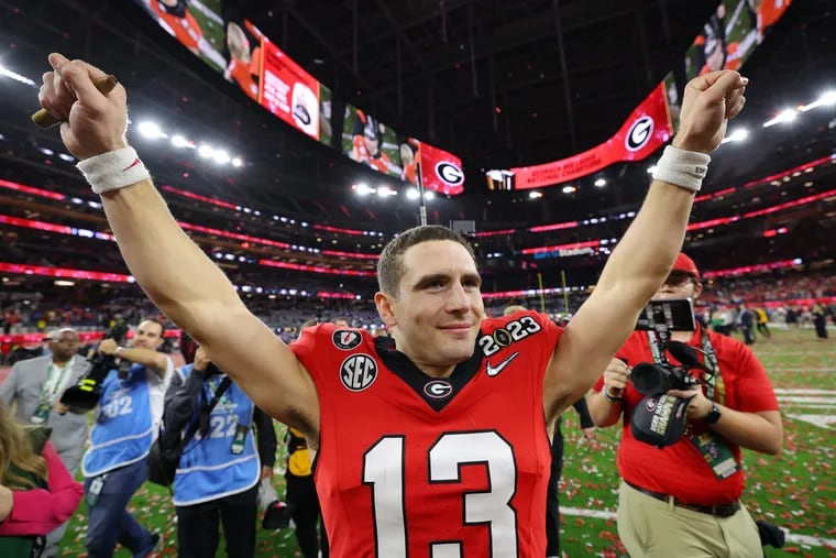Stetson Bennett (13) of the Georgia Bulldogs celebrates after defeating the TCU Horned Frogs in the College Football Playoff National Championship game at SoFi Stadium on January 09, 2023, in Inglewood, California. Georgia defeated TCU 65-7.  (Kevin C. Cox/Getty Images/TNS)