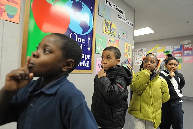 Moving quietly, pupils walk with their fingers to their lips at Chester Community Charter. The school, which already enrolls most of Chester Upland's elementary students, has filed a petition with the Delaware County Court of Common Pleas that could result in it taking over the rest of the district's primary schools.