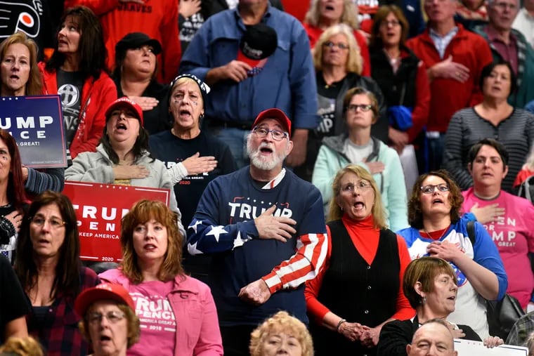 Supporters of President Donald Trump stand and sing the "The Star-Spangled Banner" before the start of a Trump rally at the Giant Center in Hershey on Dec. 10, 2019.