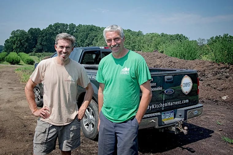 Chris Pieretti, of Kitchen Harvest Inc., and Steve Linvill, of Linvilla Orchards, at a compost pile on the farm.