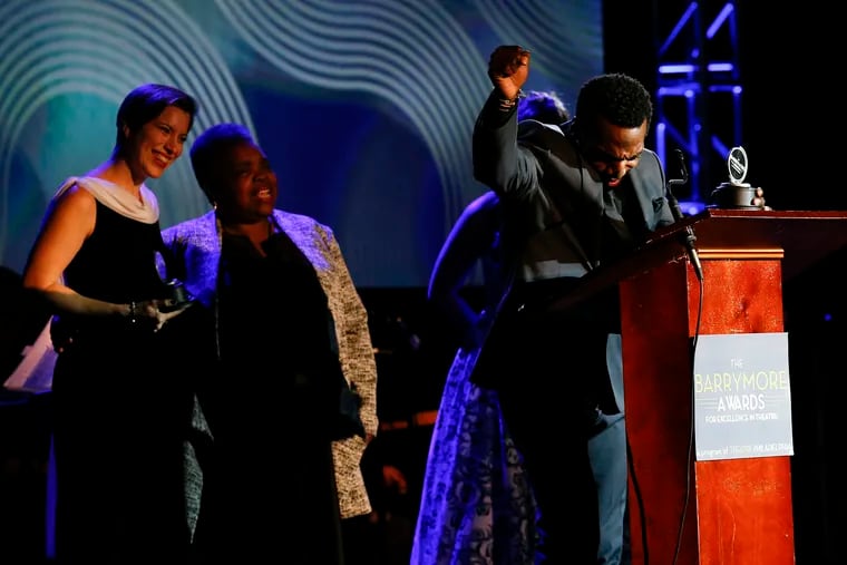 Daniel J. Watts raises his fist after winning the Outstanding Supporting Performance in a Musical as co-winner Kim Carson (left) looks on during the Barrymore Awards for Excellence in Theatre at the Bok building in South Philadelphia in November.