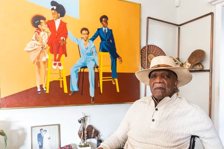 Curtis Brown, of North Philadelphia, 82, poses for a portrait in front of one of his pieces called “Cousins” at his home. “I want people to see my work to be inspired,” Brown said. “I want them to reflect on the positivity on African Americans.”