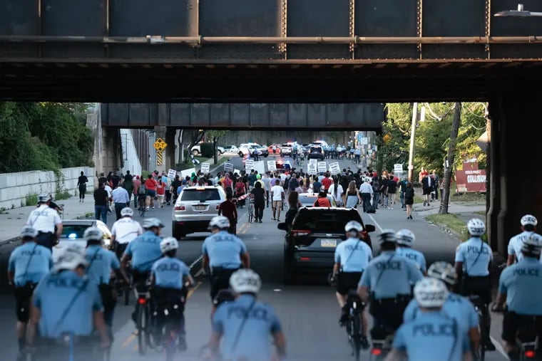Police follow a rally calling for Philadelphia Officer Mark Dial to be charged with murder in the shooting death of 27-year-old Eddie Irizarry. The group is marching to the 24th Police district Thursday, Aug. 31, 2023.