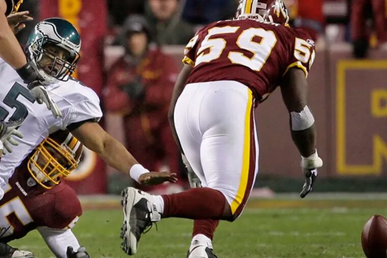 Redskins&#0039; London Fletcher (right) goes after ball fumbled by Donovan McNabb in third quarter.