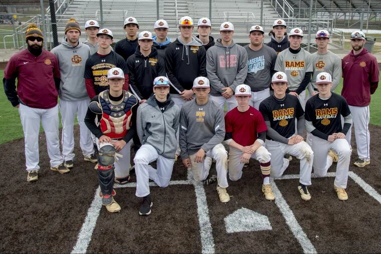 The Gloucester Catholic baseball team poses for a photo before a scrimmage at Eastern, March 27, 2018. Head coach Adam Tussey is at far right. TOM GRALISH / Staff Photographer 