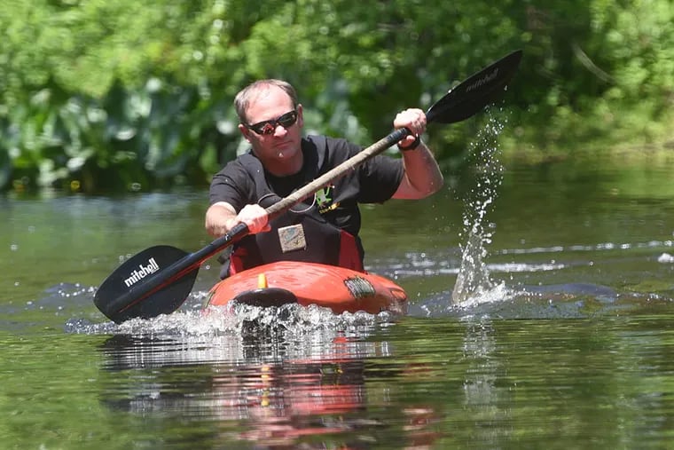 John Anderson of Westampton, a fan of Rancocas Creek, paddles his kayak in the creek in Mount Holly near Mill Dam Park. “All you hear is nature,” he said. “It’s hypnotic. It’s an escape from everything around us.” (CURT HUDSON / For The Inquirer)
