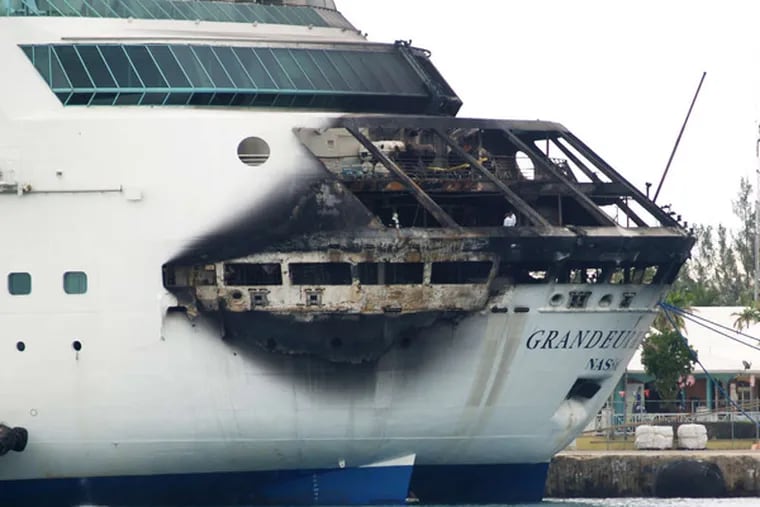 The stern of Royal Caribbean's Grandeur of the Seas shows extensive fire damage at the dock in Freeport, Bahamas. (JENNEVA RUSSELL / Freeport News)