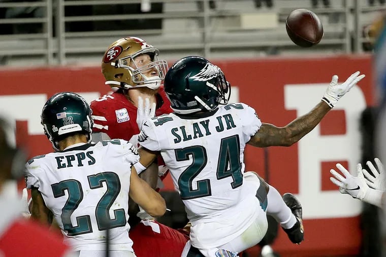 Eagles cornerback Darius Slay (right) tips the final pass of the game away from 49ers tight end George Kittle (center) to end the game on Sunday night.