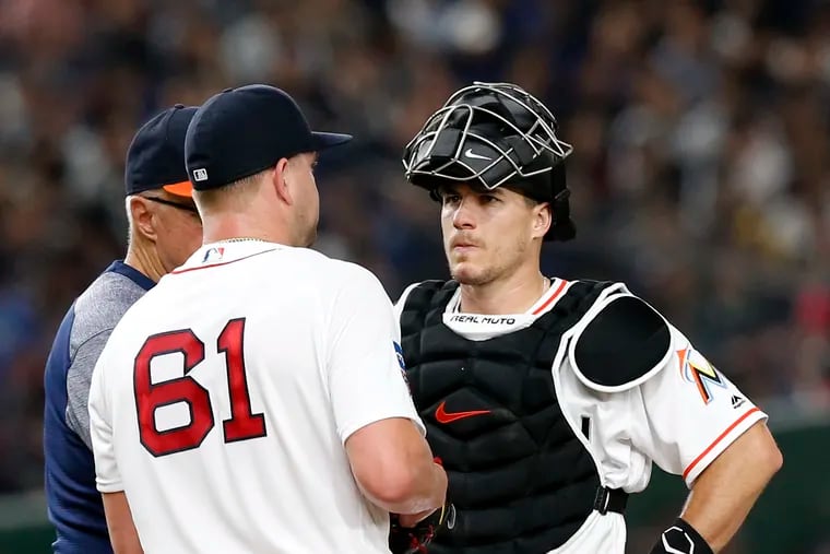 MLB All-Star catcher J.T. Realmuto of the Miami Marlins talks with pitcher Brian Johnson (61) of the Boston Red Sox on the mound after giving up four runs against All Japan in the fifth inning of Game 2 of their All-Stars Series baseball at Tokyo Dome in Tokyo, Saturday, Nov. 10, 2018. (AP Photo/Toru Takahashi)