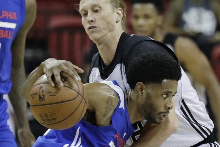 Philadelphia 76ers guard Larry Drew II drives into the San Antonio Spurs’ Jeff Ledbetter during the first half of an NBA summer league basketball game, Sunday, July 9, 2017, in Las Vegas.