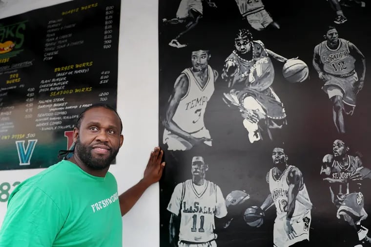 Former St. Joseph's basketball player Marvin O'Connor stands for a portrait at the Fresh Works shop he co-owns in Philadelphia's Point Breeze section.