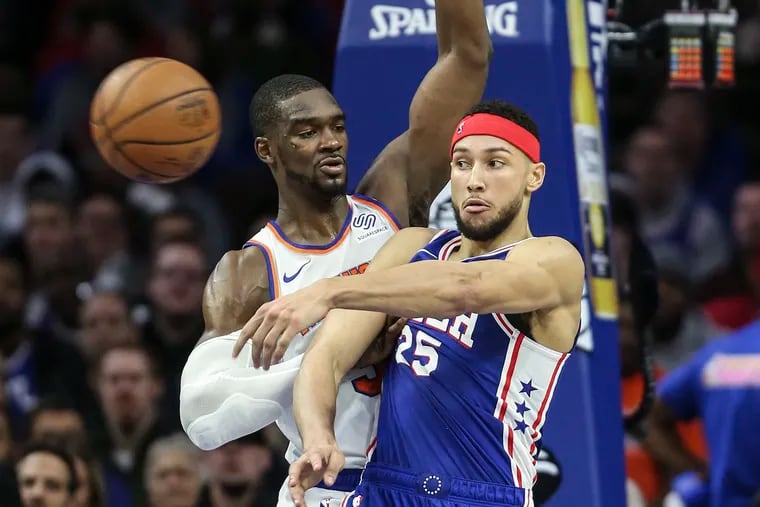 The Sixers' Ben Simmons throws a pass in front of the Knicks' Noah Vonleh during the third quarter.