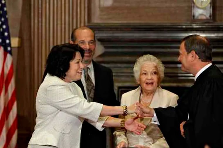 After taking the oath to become the Supreme Court's newest justice, Sonia Sotomayor reached out yesterday to Chief Justice John Roberts. She was joined by her brother, Juan Luis Sotomayor, and her mother, Celina Sotomayor.