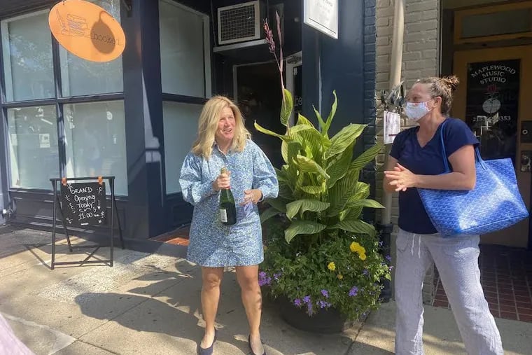 Owner of booked. Debra Gress Jansen thanks friend Megan Traversari for a celebratory bottle of champagne on the store's grand opening.