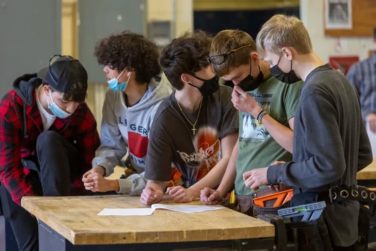 Carpentry students look at plans at the start of class at Gloucester County Institute of Technology.