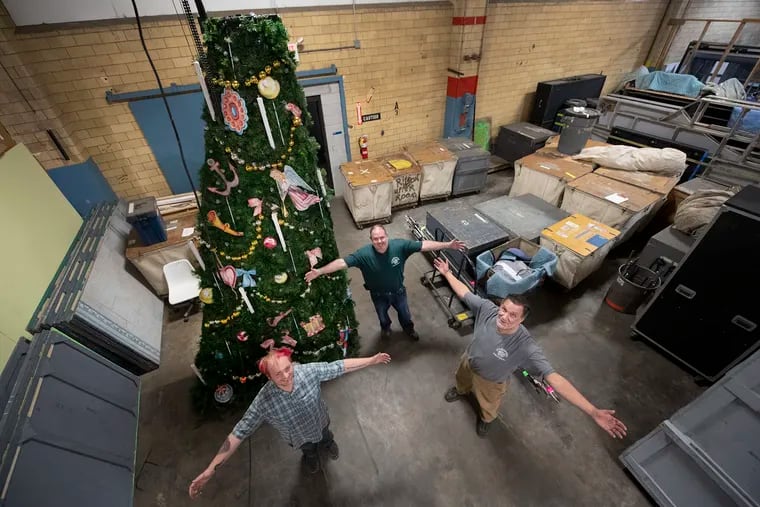 From left, Uel Bergey, master electrician, Dave Amadie, property master, and Paul Hewitt, head carpenter, pose with a vertical slice of the "Nutcracker's" upgraded Christmas tree at the Pennsylvania Ballet's warehouse in Sharon Hill, Pa.